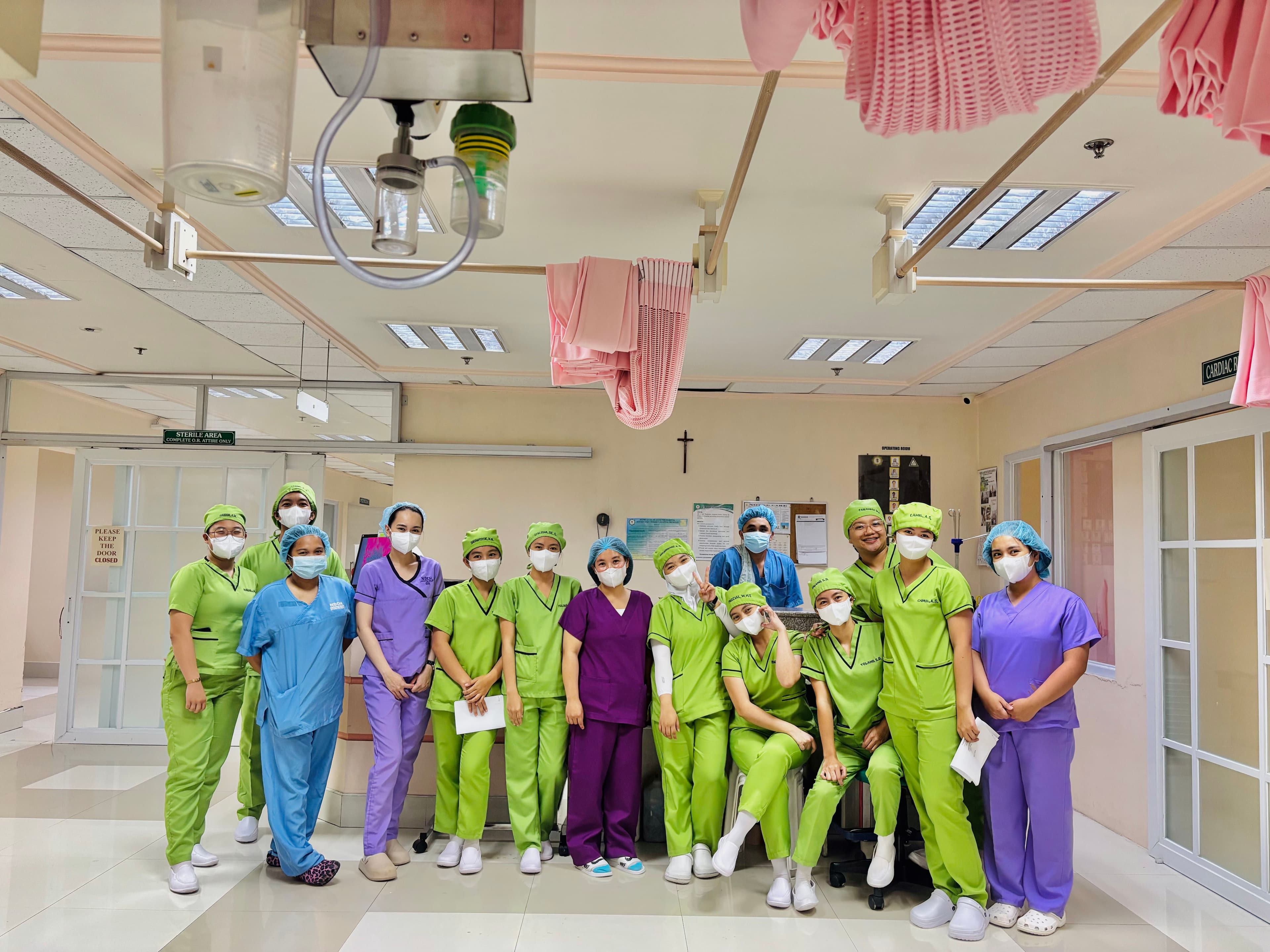 A graduating class of CNA students in scrubs