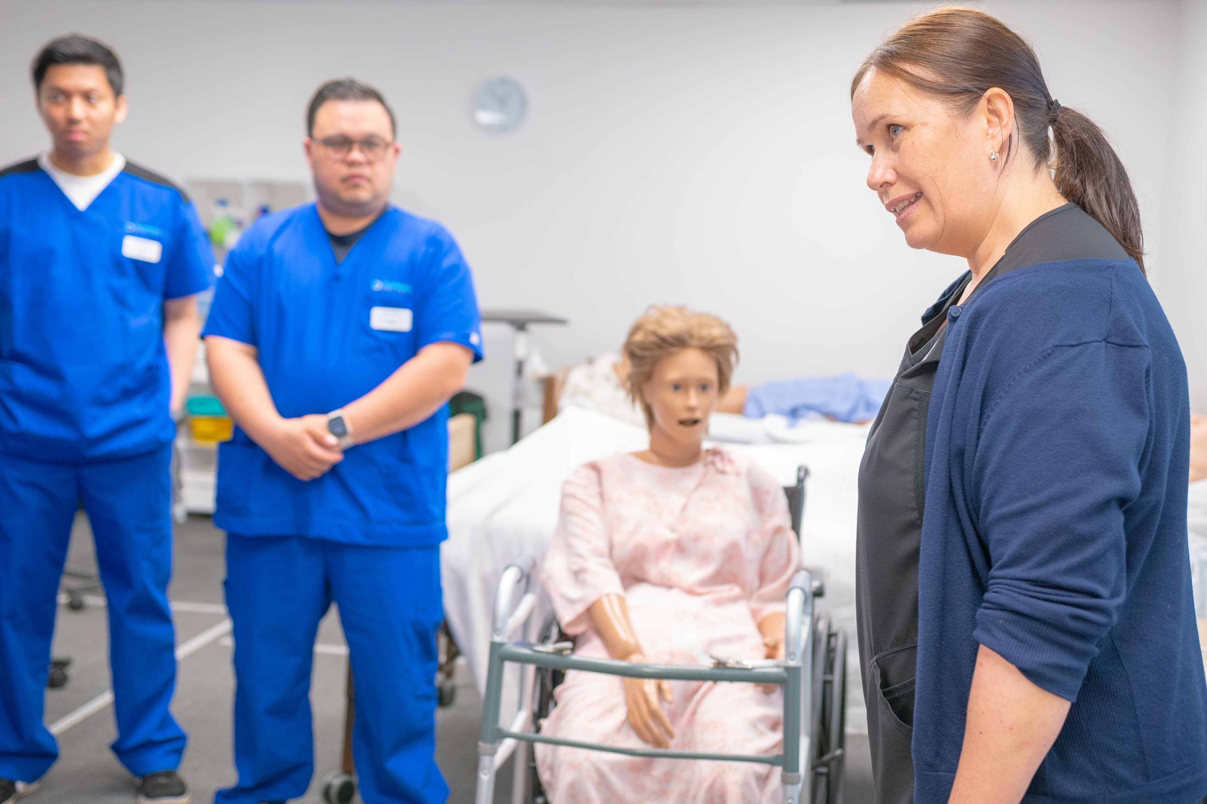 CNA students practicing hands-on patient care during a clinical simulation